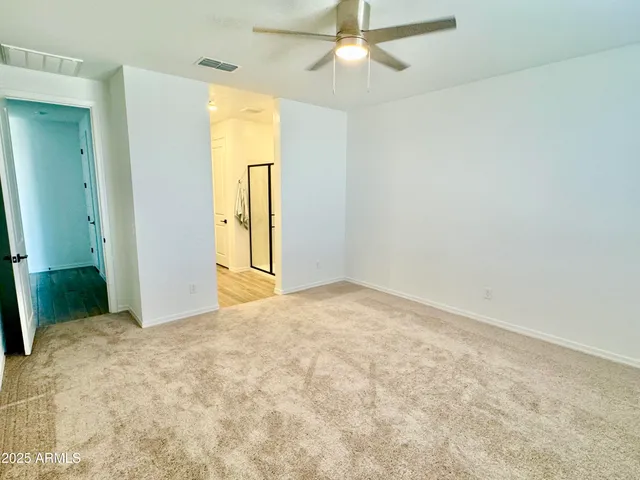 a view of a big room with closet and windows