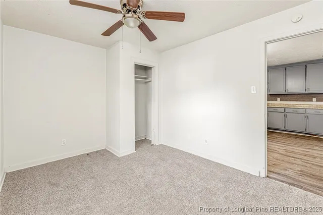 a view of a kitchen with a sink and a refrigerator