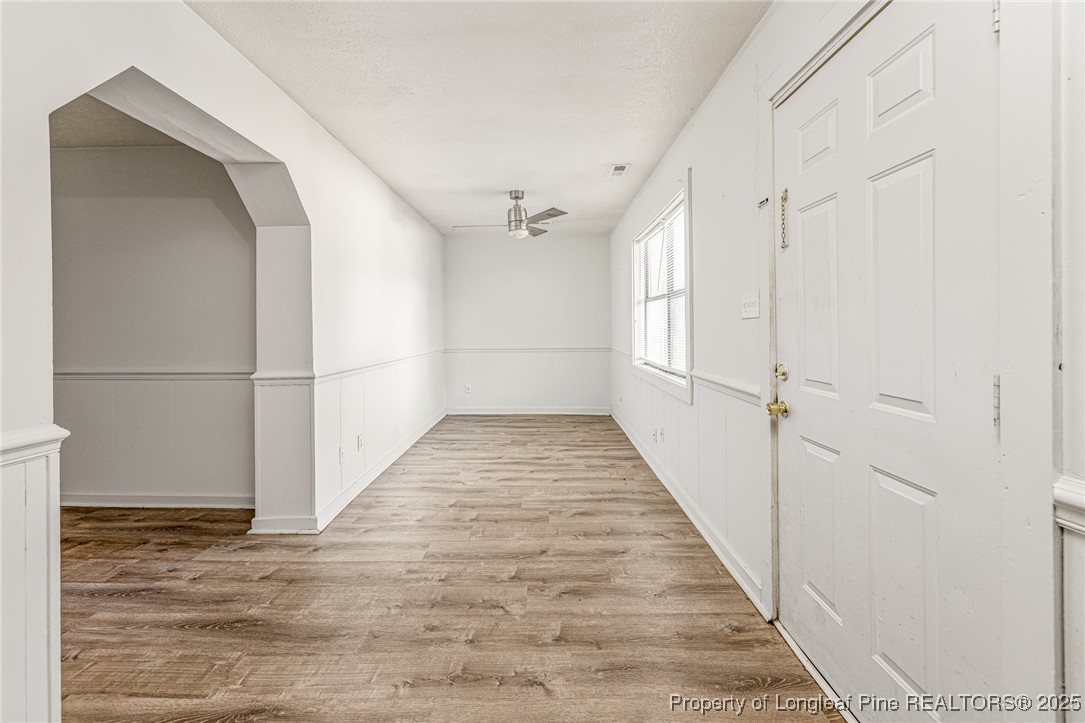 210 South Plymouth Street, Unit 1 Fayetteville, NC 28312 - Photo 16 of 26 a view of a hallway with wooden floor and staircase