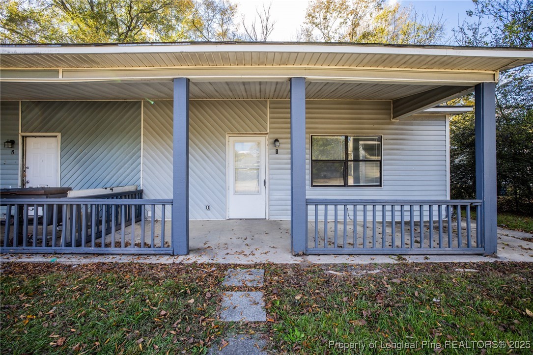 210 South Plymouth Street, Unit 1 Fayetteville, NC 28312 - Photo 4 of 26 a view of a house with a small yard and wooden floor and fence