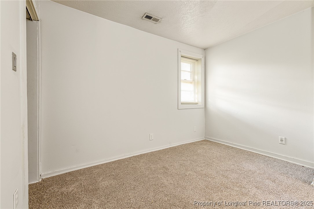 210 South Plymouth Street, Unit 1 Fayetteville, NC 28312 - Photo 7 of 26 an empty room with windows