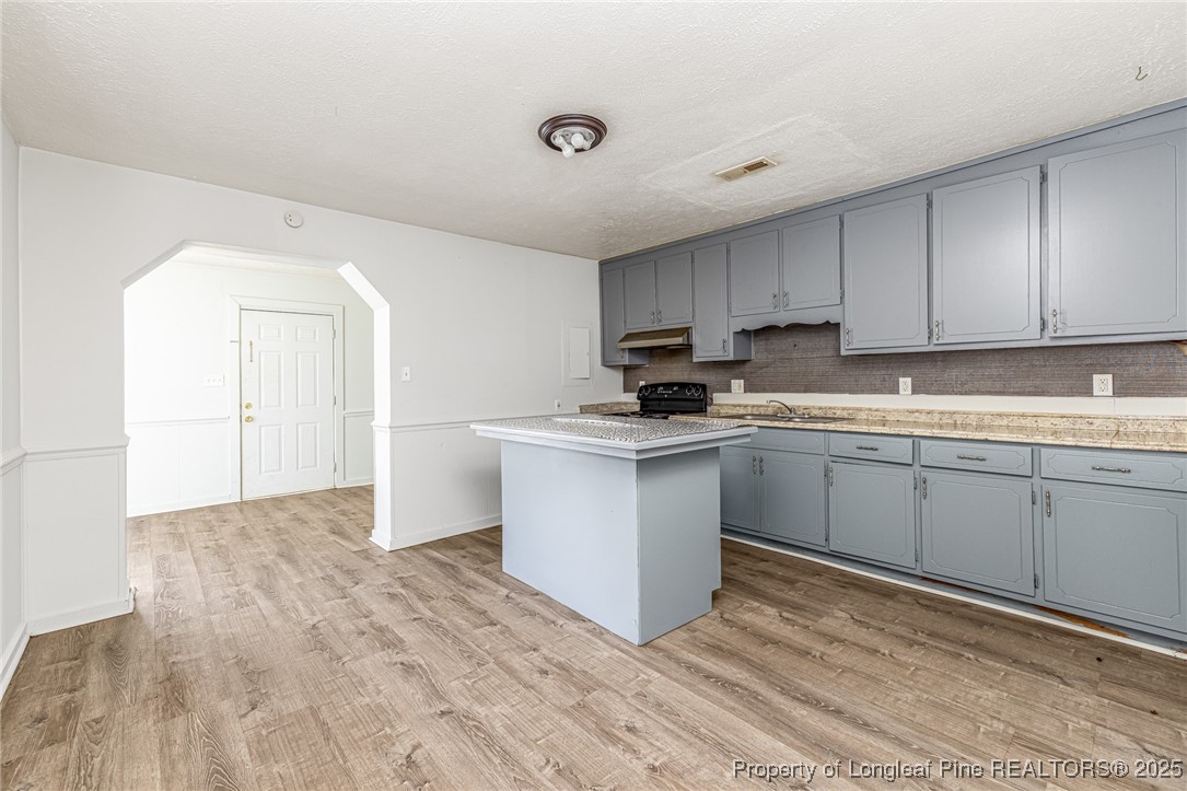 210 South Plymouth Street, Unit 1 Fayetteville, NC 28312 - Photo 9 of 26 a kitchen with granite countertop white cabinets and white appliances