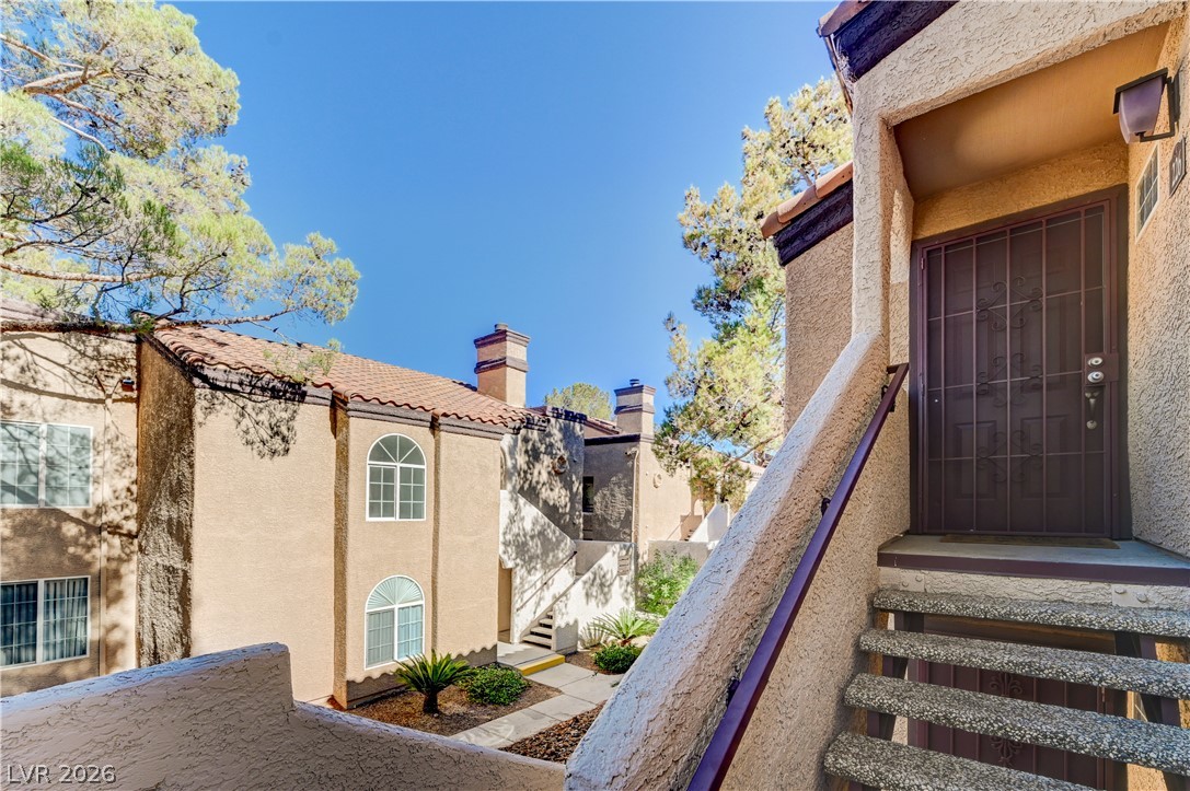 9325 West Desert Inn Road, Unit 226 Las Vegas, NV 89117 - Photo 28 of 29 A Mediterranean-inspired complex with terracotta roofs and lush landscaping awaits.
