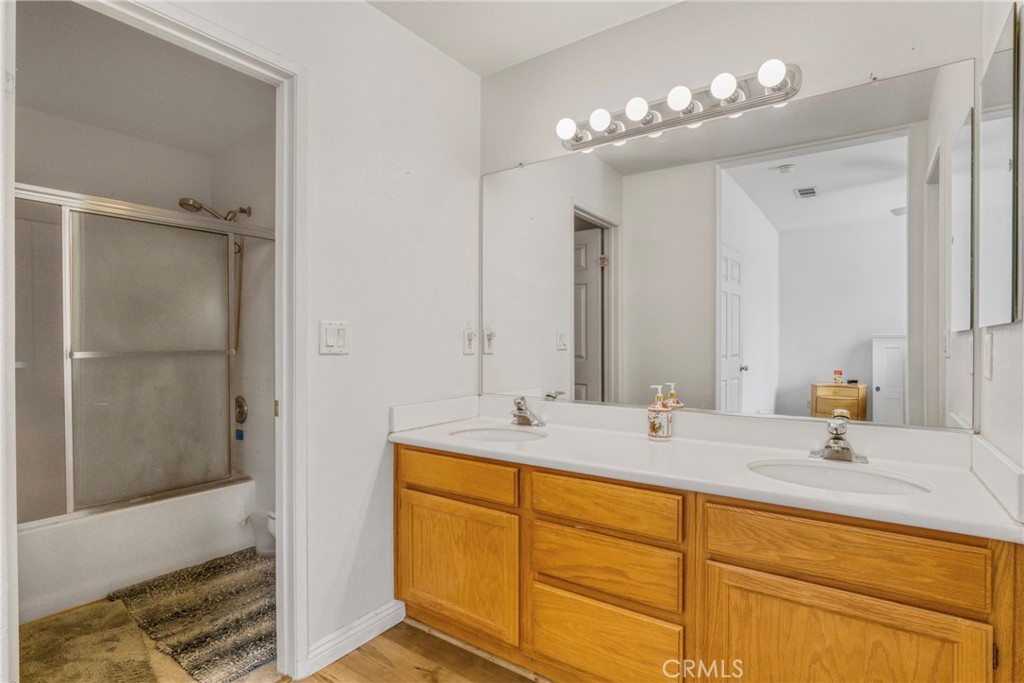 22754 Little Falls Court Saugus, CA 91350 - Photo 11 of 33 a bathroom with a sink double vanity and shower