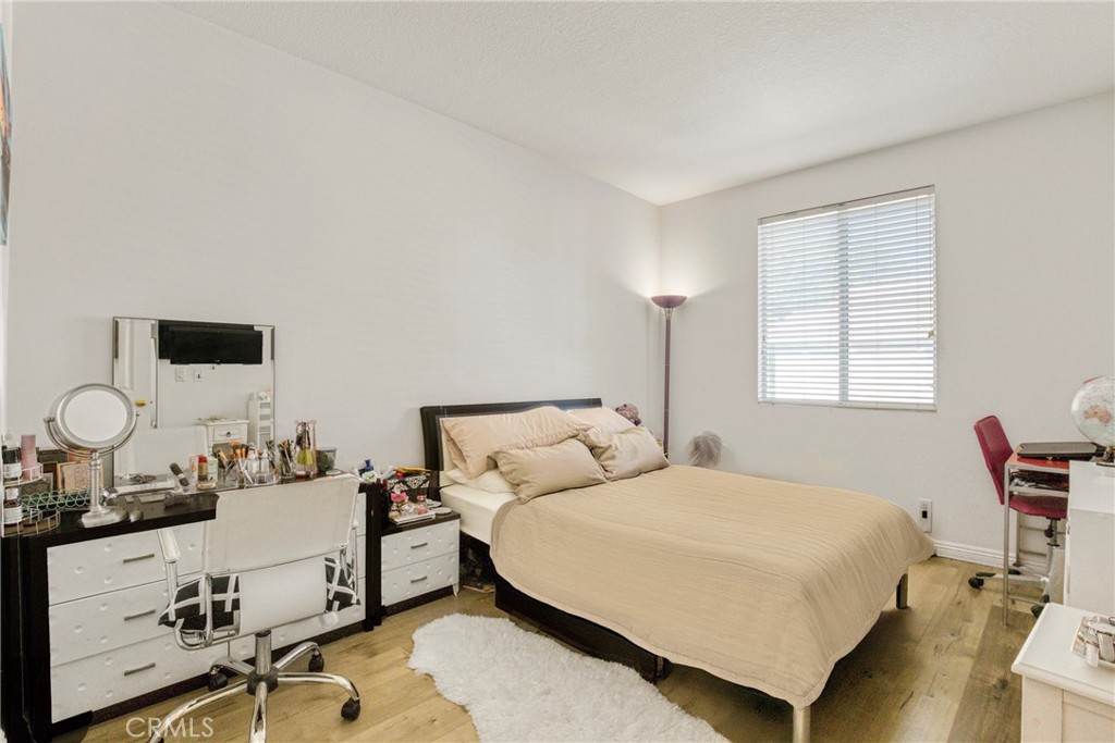 22754 Little Falls Court Saugus, CA 91350 - Photo 13 of 33 a bedroom with a bed and dresser with mirror