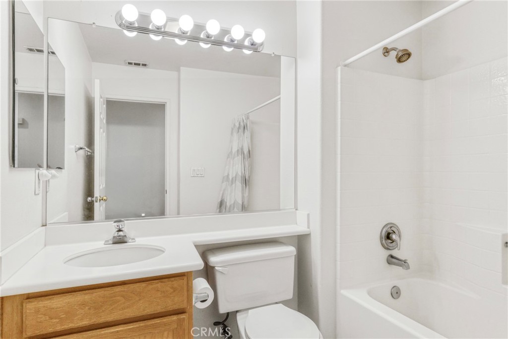 22754 Little Falls Court Saugus, CA 91350 - Photo 15 of 33 a bathroom with a granite countertop sink a toilet and shower