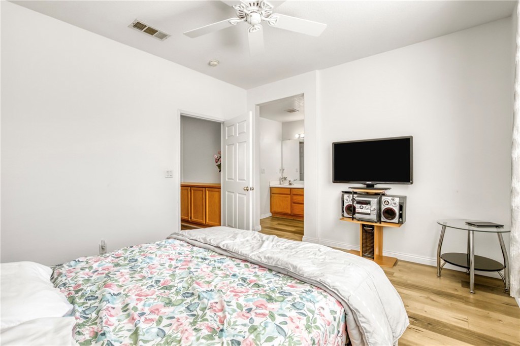 22754 Little Falls Court Saugus, CA 91350 - Photo 17 of 33 a bedroom with a bed and a flat screen tv