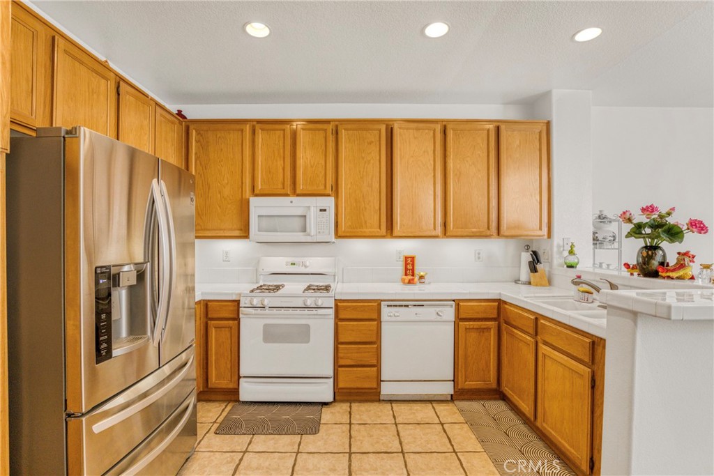22754 Little Falls Court Saugus, CA 91350 - Photo 6 of 33 a kitchen with a sink stove and refrigerator