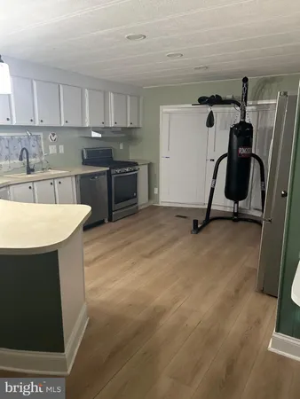 a view of a storage & utility room with refrigerator