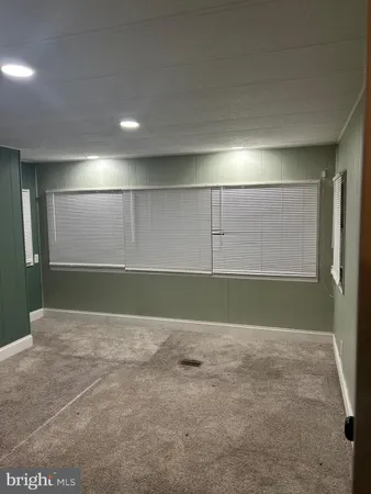 a view of a kitchen with kitchen island a sink a stove and a refrigerator