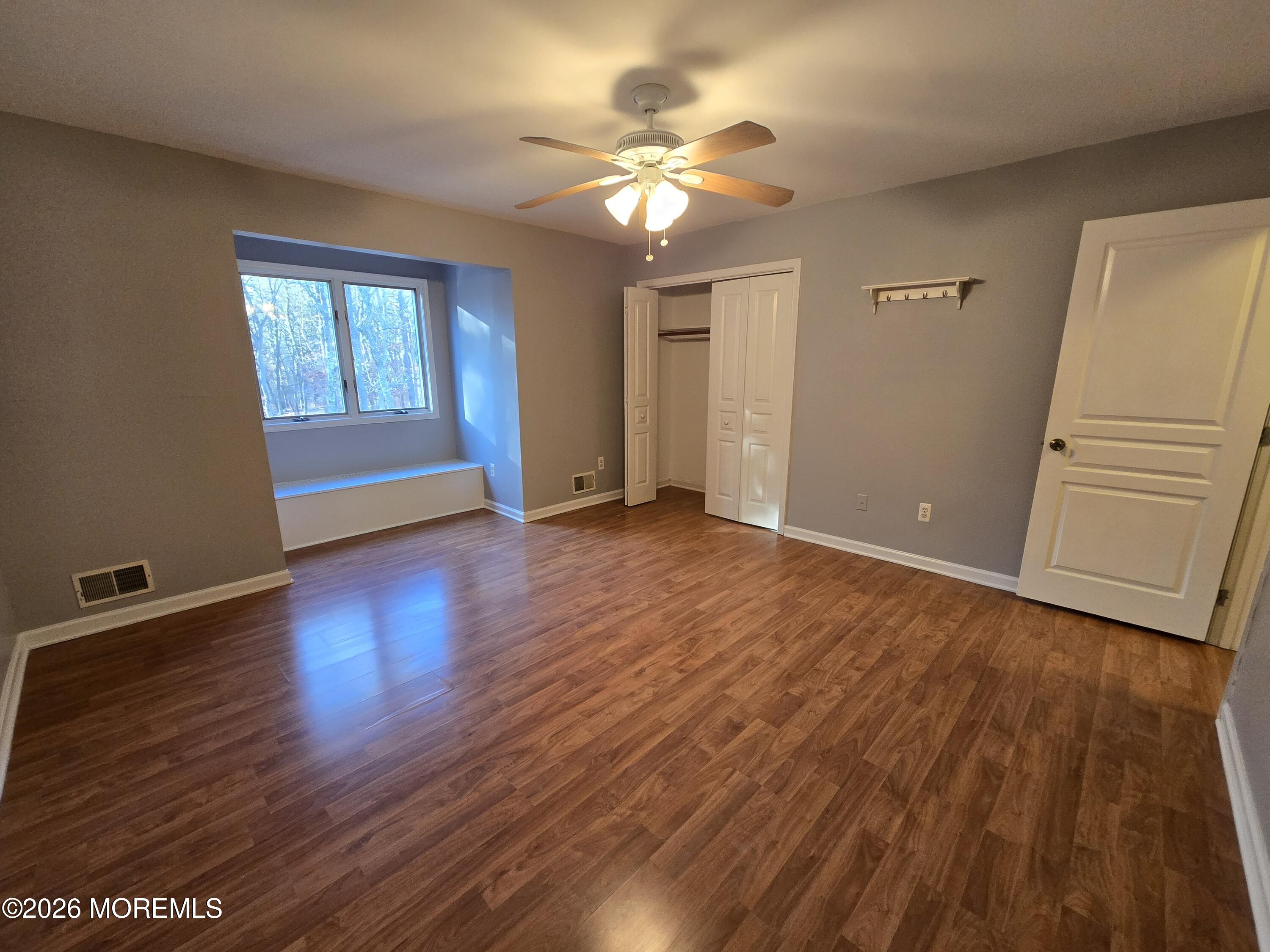 274 Easy Street, Unit RIGHT Howell, NJ 07731 - Photo 12 of 19 a view of an empty room with wooden floor and a window