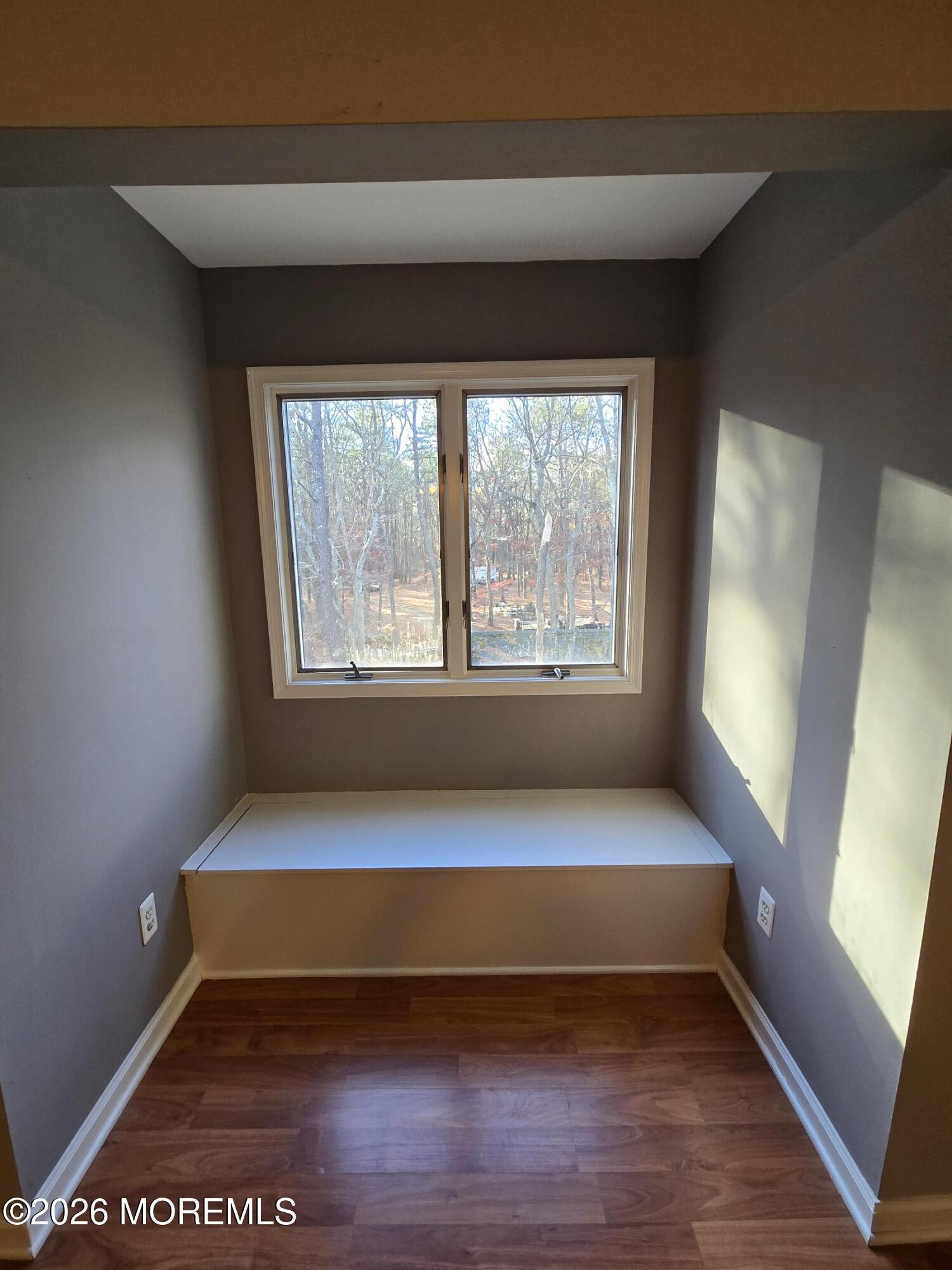 274 Easy Street, Unit RIGHT Howell, NJ 07731 - Photo 16 of 19 a view of an empty room with wooden floor and a window