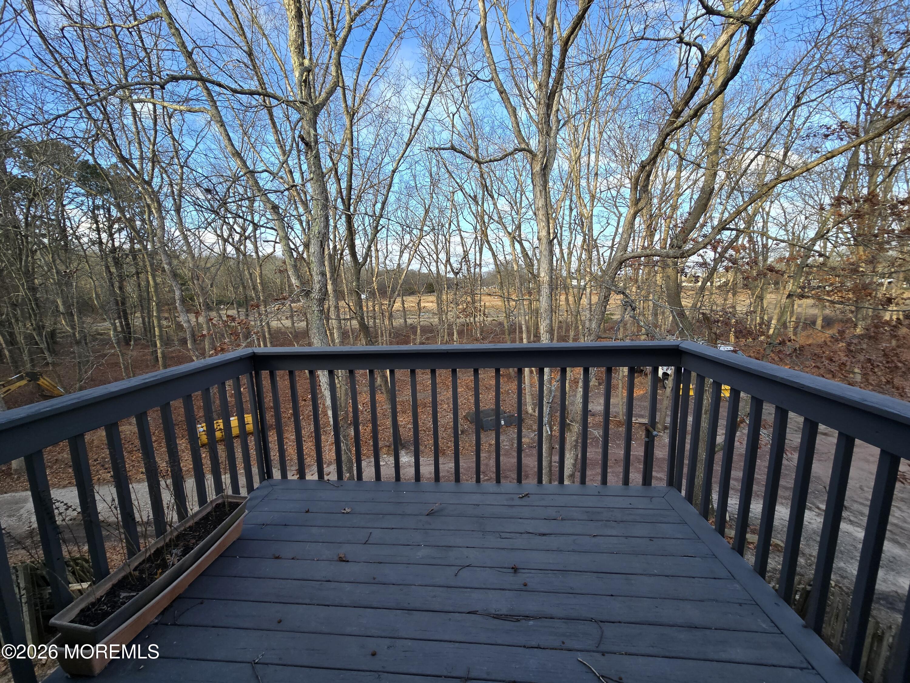 274 Easy Street, Unit RIGHT Howell, NJ 07731 - Photo 17 of 19 a balcony with wooden floor and fence