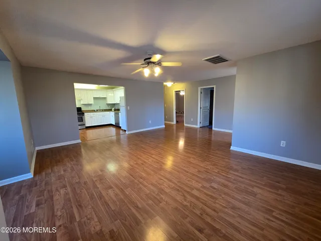 a view of a room with wooden floor