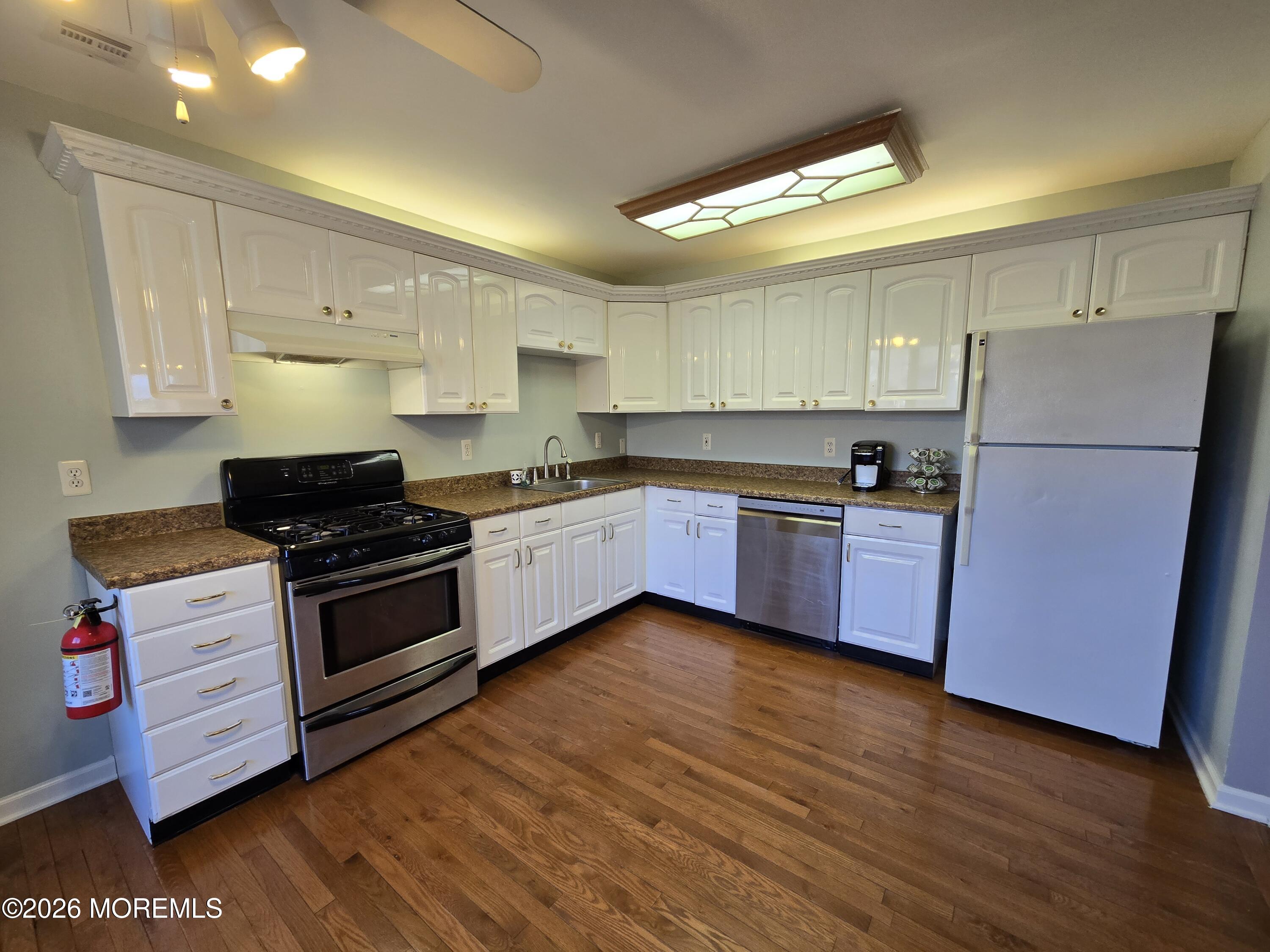 274 Easy Street, Unit RIGHT Howell, NJ 07731 - Photo 6 of 19 a kitchen with granite countertop a sink a counter space stainless steel appliances and cabinets