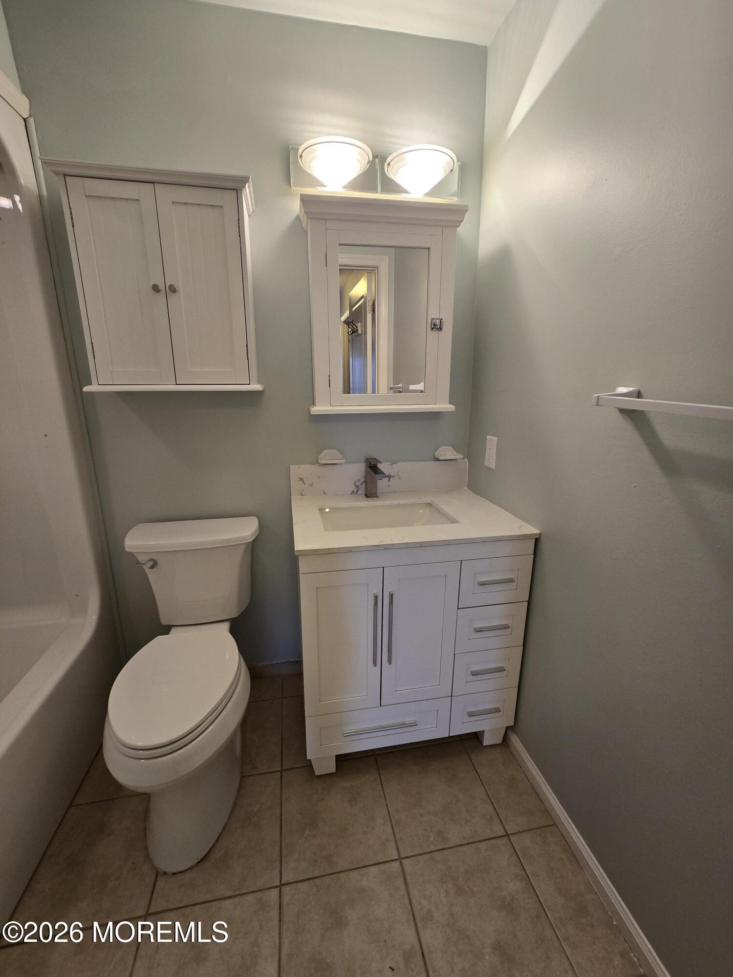 274 Easy Street, Unit RIGHT Howell, NJ 07731 - Photo 9 of 19 a bathroom with a toilet sink and mirror