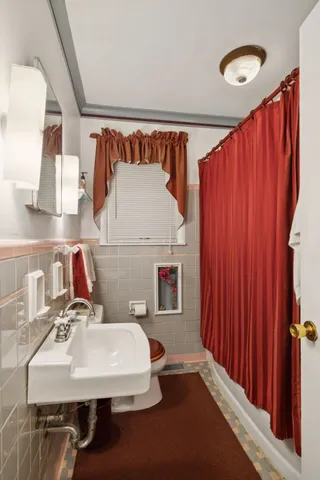 a bedroom with bed and window