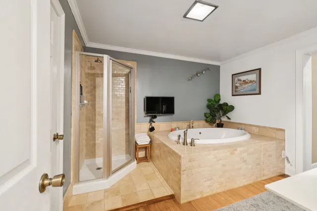 a bedroom with a bed and a large mirror