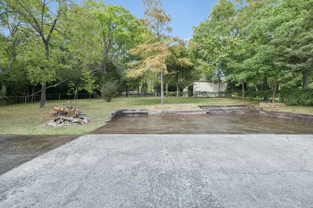 a view of a house with a yard and potted plants