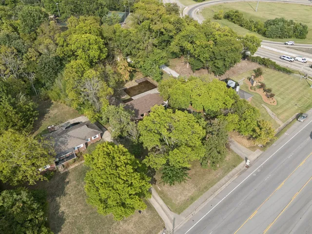 an aerial view of a house with a yard