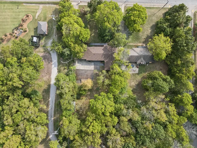 a view of a city with lush green forest