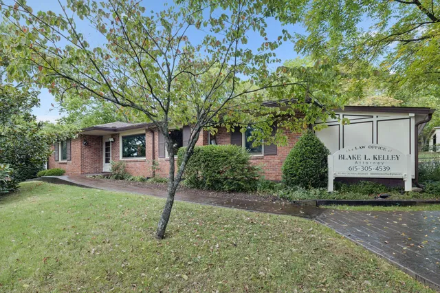 a view of a yard with potted plants