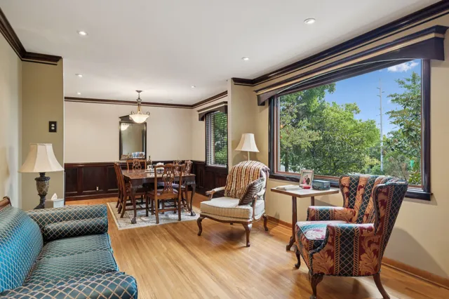 a view of a a dining room with furniture window and wooden floor