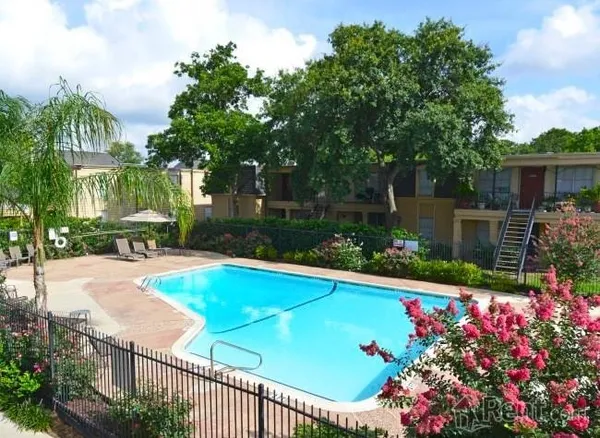 a view of a backyard with sitting area and garden