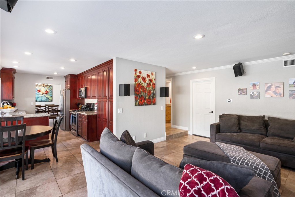 25671 Westover Circle Lake Forest, CA 92630 - Photo 12 of 37 a living room with furniture and a dining table with kitchen view