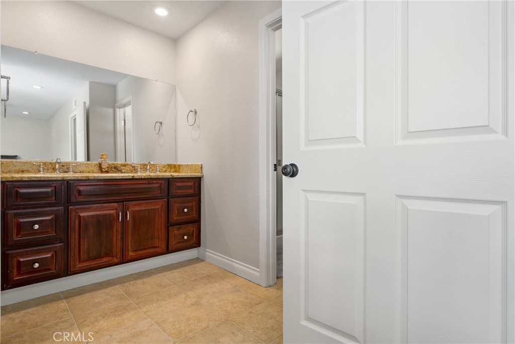 25671 Westover Circle Lake Forest, CA 92630 - Photo 24 of 37 a bathroom with a granite countertop sink and a mirror