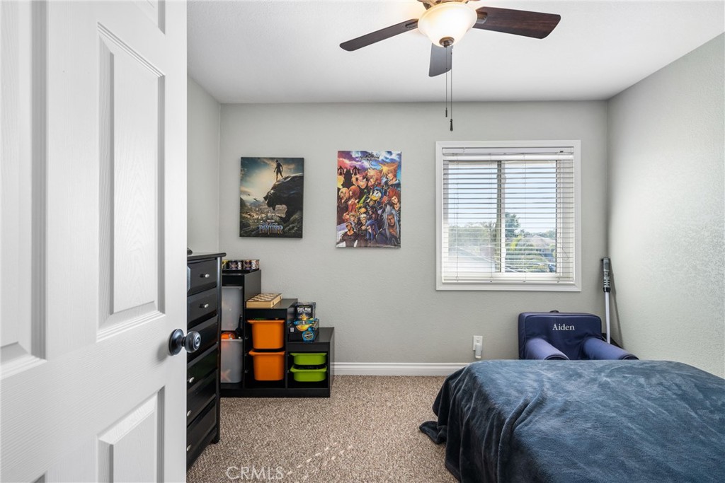 25671 Westover Circle Lake Forest, CA 92630 - Photo 28 of 37 a bedroom with a bed and a chandelier