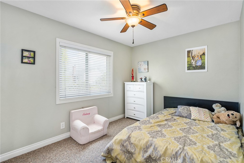 25671 Westover Circle Lake Forest, CA 92630 - Photo 31 of 37 a bedroom with a bed and a chandelier