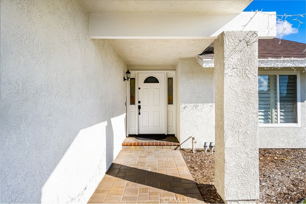 25671 Westover Circle Lake Forest, CA 92630 - Photo 4 of 37 a view of a hallway with wooden floor and a living room