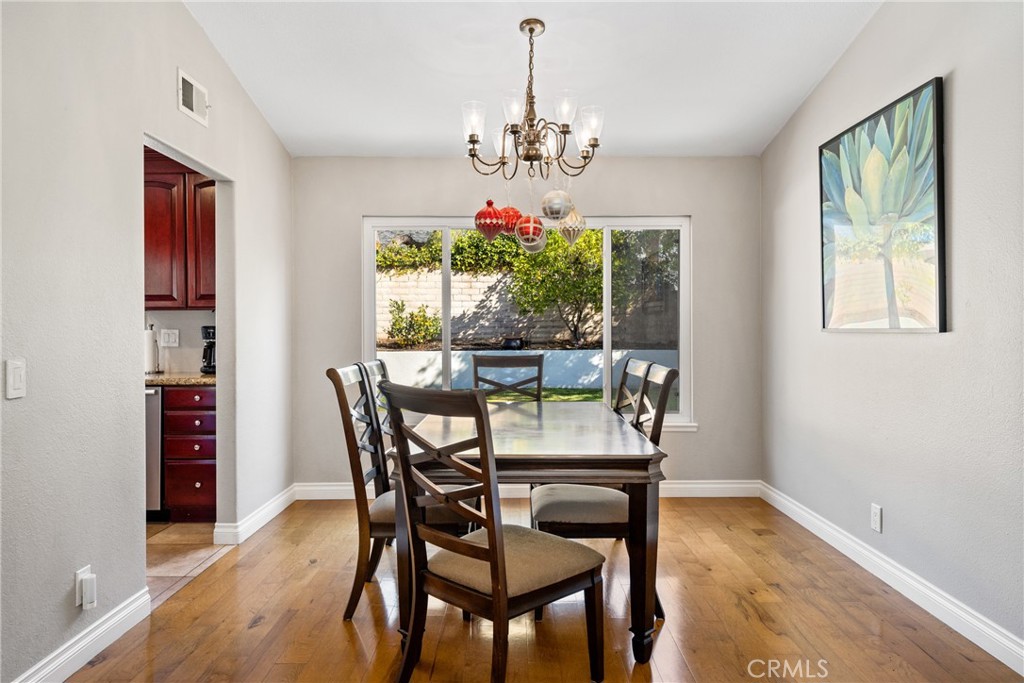 25671 Westover Circle Lake Forest, CA 92630 - Photo 9 of 37 a dining room with furniture a chandelier and window