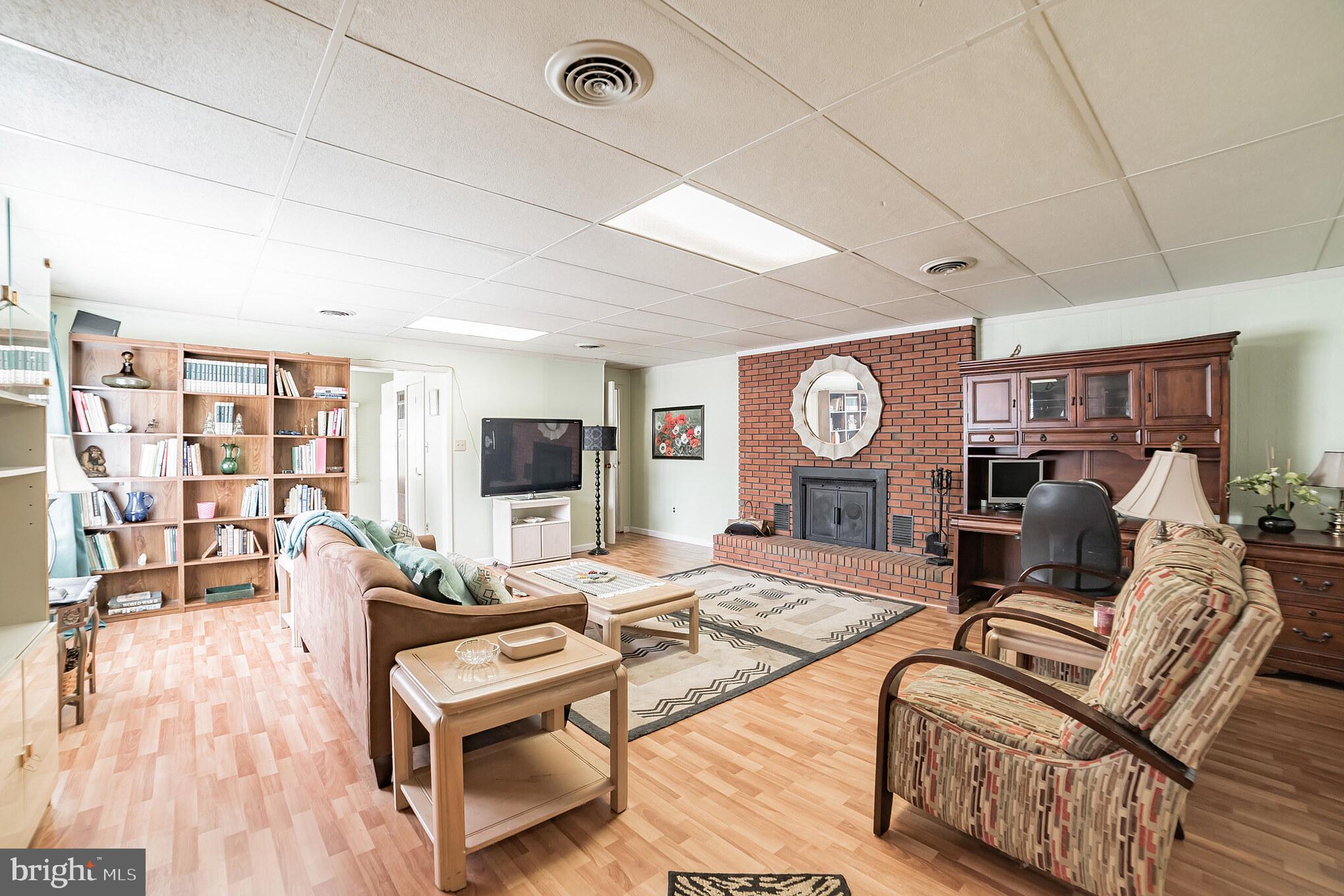 612 Carvel Grove Road Baltimore, MD 21221 - Photo 4 of 21 a living room with furniture a flat screen tv and a clock