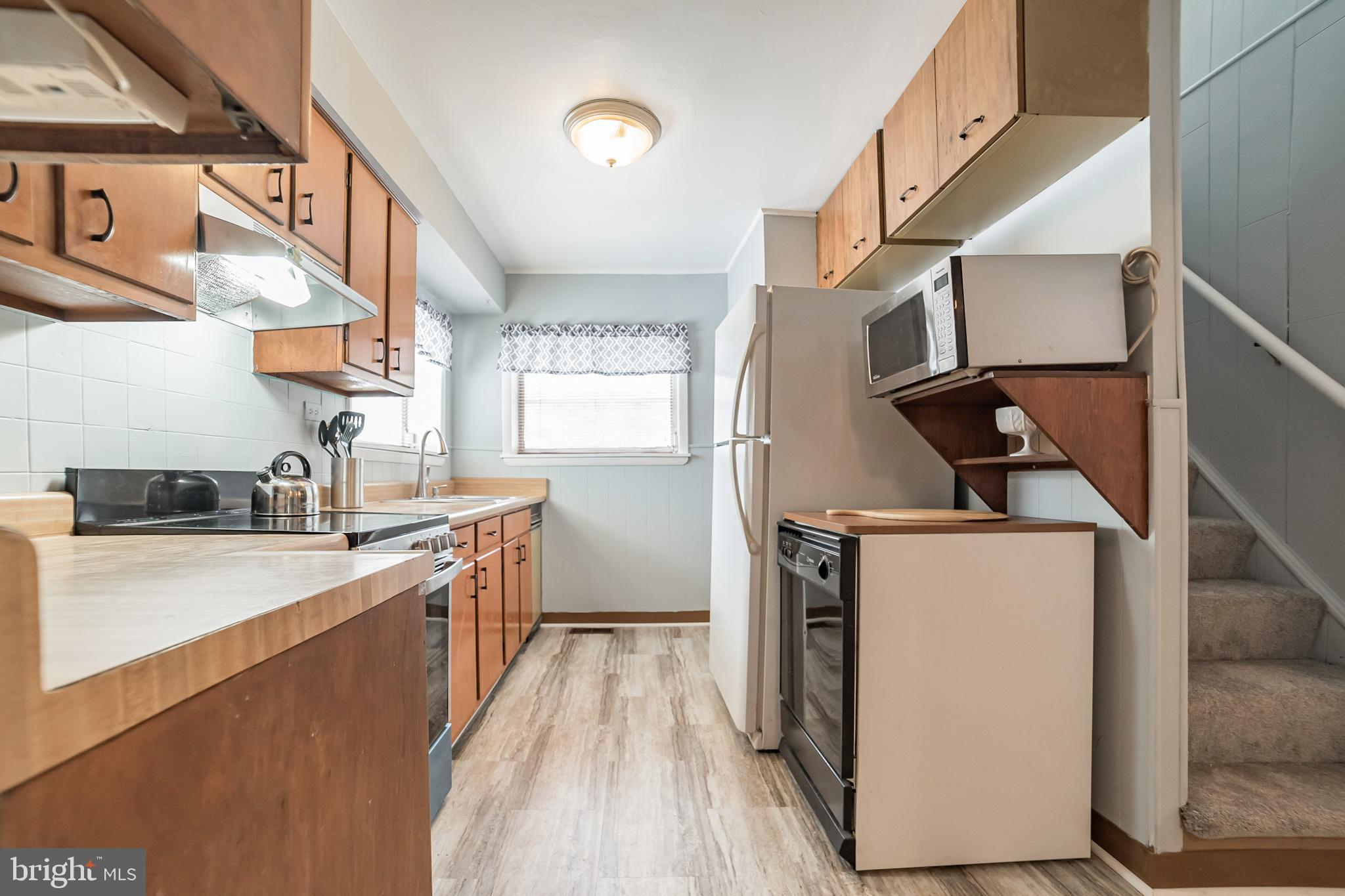 612 Carvel Grove Road Baltimore, MD 21221 - Photo 10 of 21 a kitchen with stainless steel appliances granite countertop a sink a stove and a refrigerator