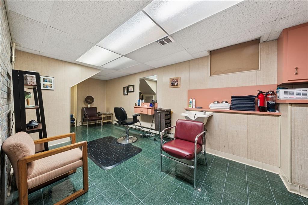 353 Linnwood Road Eighty Four, PA 15330 - Photo 24 of 36 a living room with furniture a rug and a flat screen tv