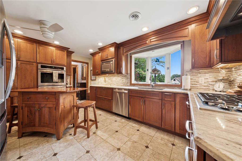 353 Linnwood Road Eighty Four, PA 15330 - Photo 7 of 36 a kitchen with stainless steel appliances granite countertop a sink stove and refrigerator