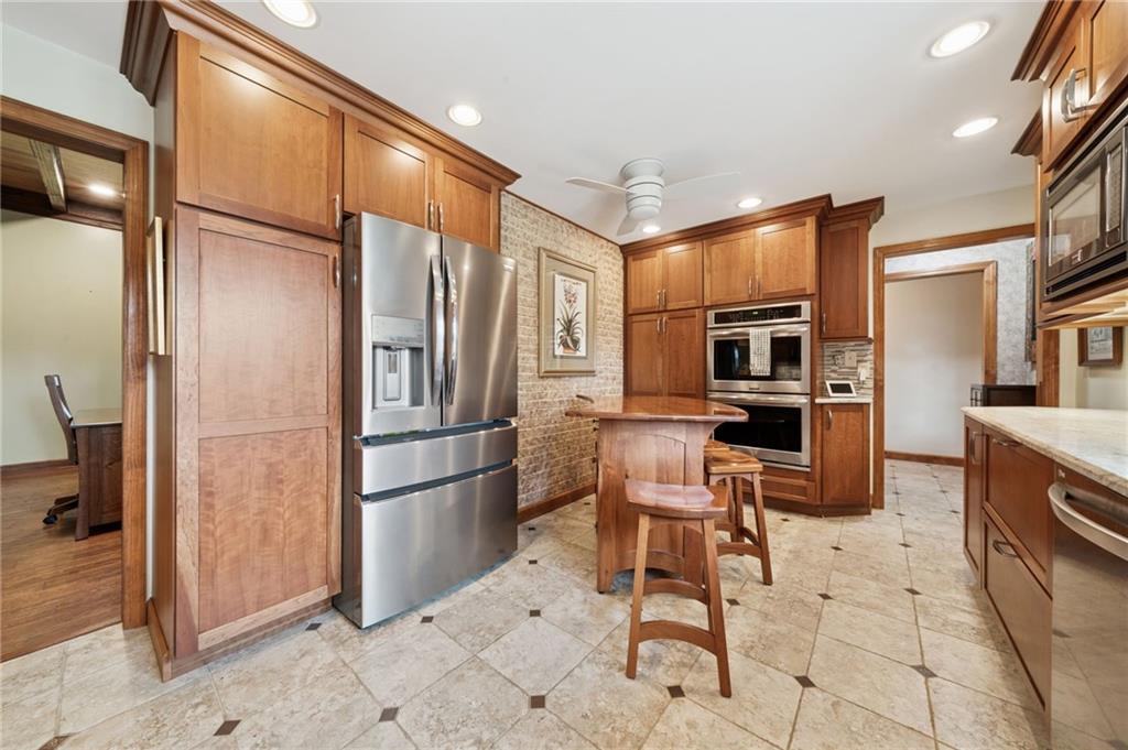 353 Linnwood Road Eighty Four, PA 15330 - Photo 8 of 36 a kitchen with granite countertop a refrigerator and furniture