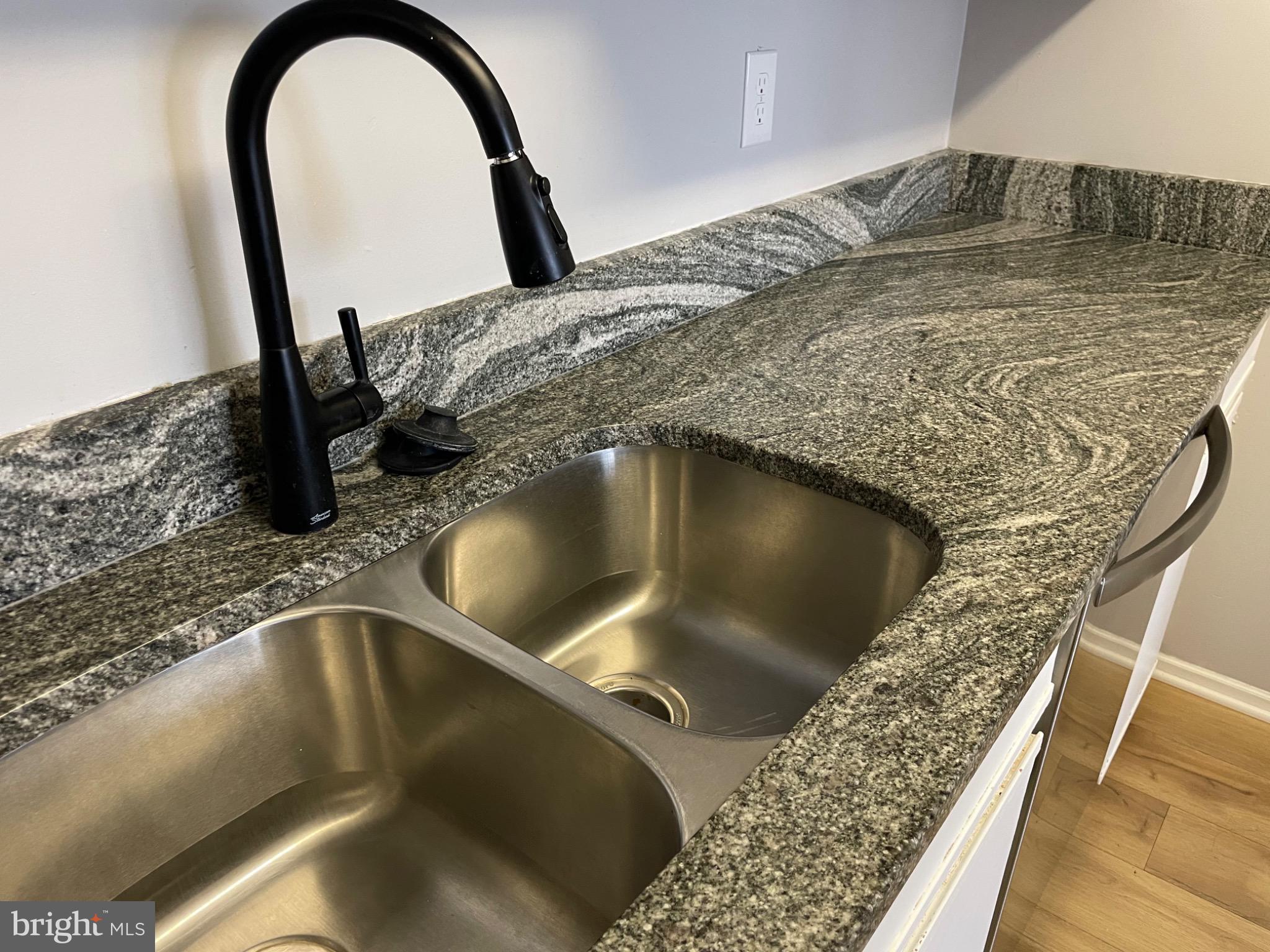 1401 Key Parkway, Unit 204 Frederick, MD 21702 - Photo 24 of 27 Sleek granite countertop with modern fixtures.