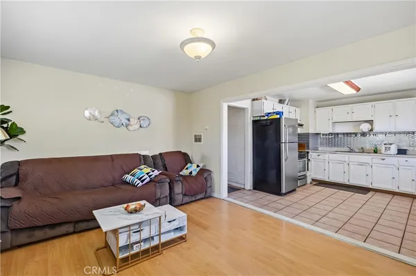 a living room with furniture and kitchen view