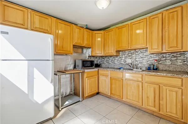 a kitchen with stainless steel appliances granite countertop a refrigerator sink and cabinets