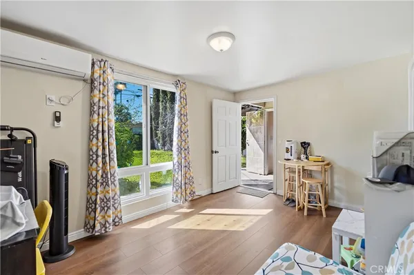 a living room with furniture a window and gym equipment