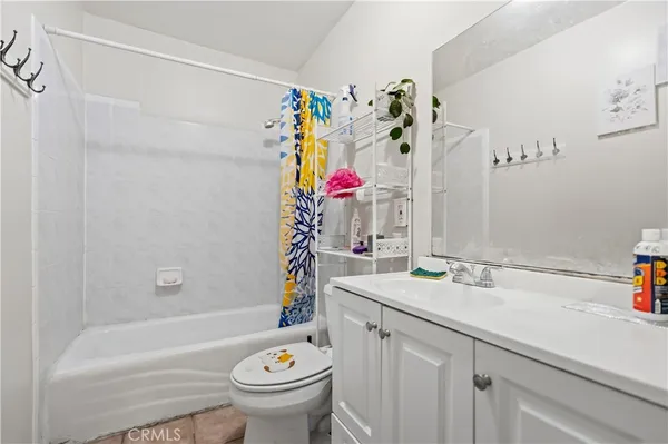 a bathroom with a sink mirror toilet and bathtub