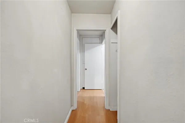 a view of a room with wooden floor