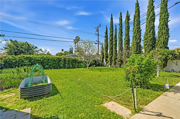 a view of a backyard with lawn chairs