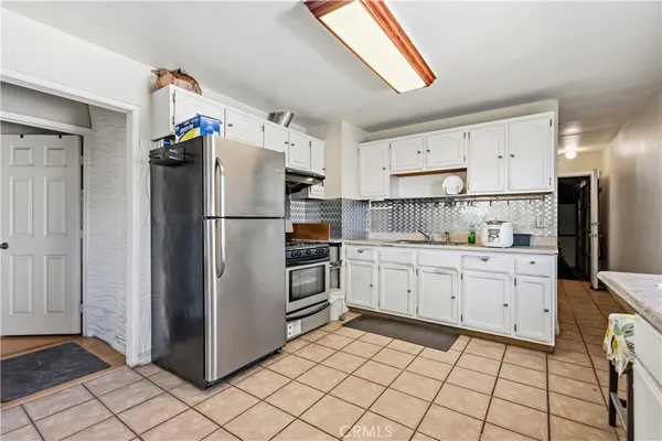 a kitchen with cabinets stainless steel appliances and counter space