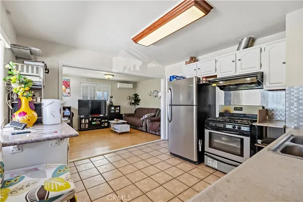 a refrigerator and a stove sitting inside of a kitchen