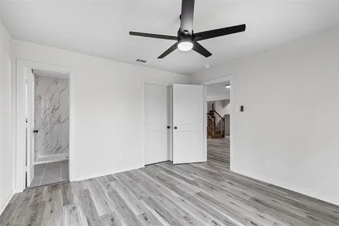 a view of wooden floor and windows in a room