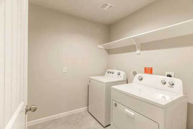 a view of storage and utility room with washer and dryer